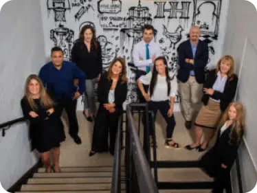 Group of people standing on a staircase landing 