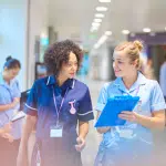 Interim Director of Nursing Conferring with Nurse